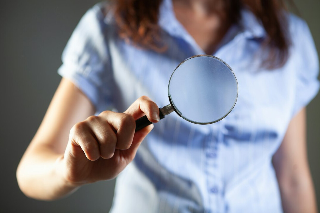 person examining evidence with magnifying glass